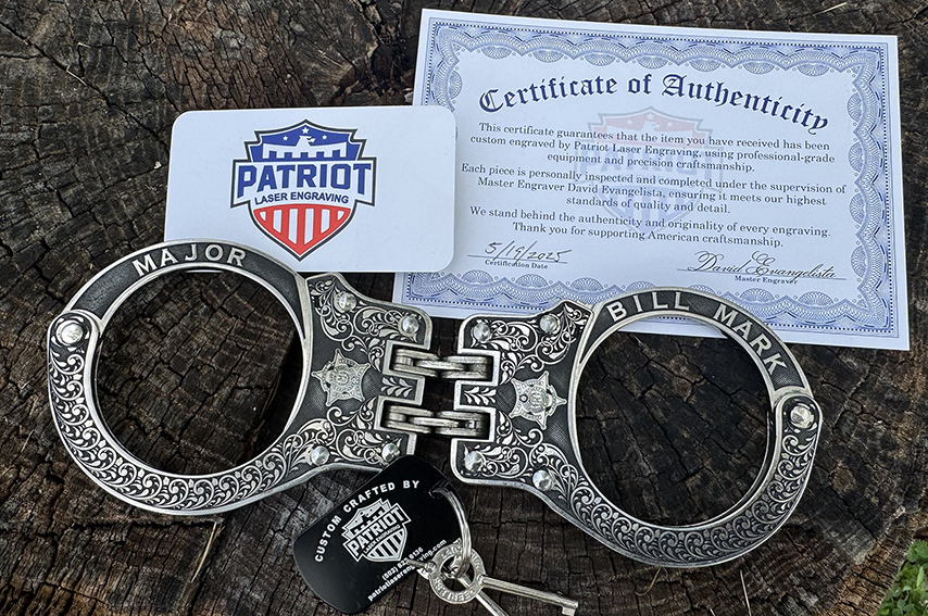 A photo of a pair of deep engraved cuffs with a card containing the thin blue line series logo.